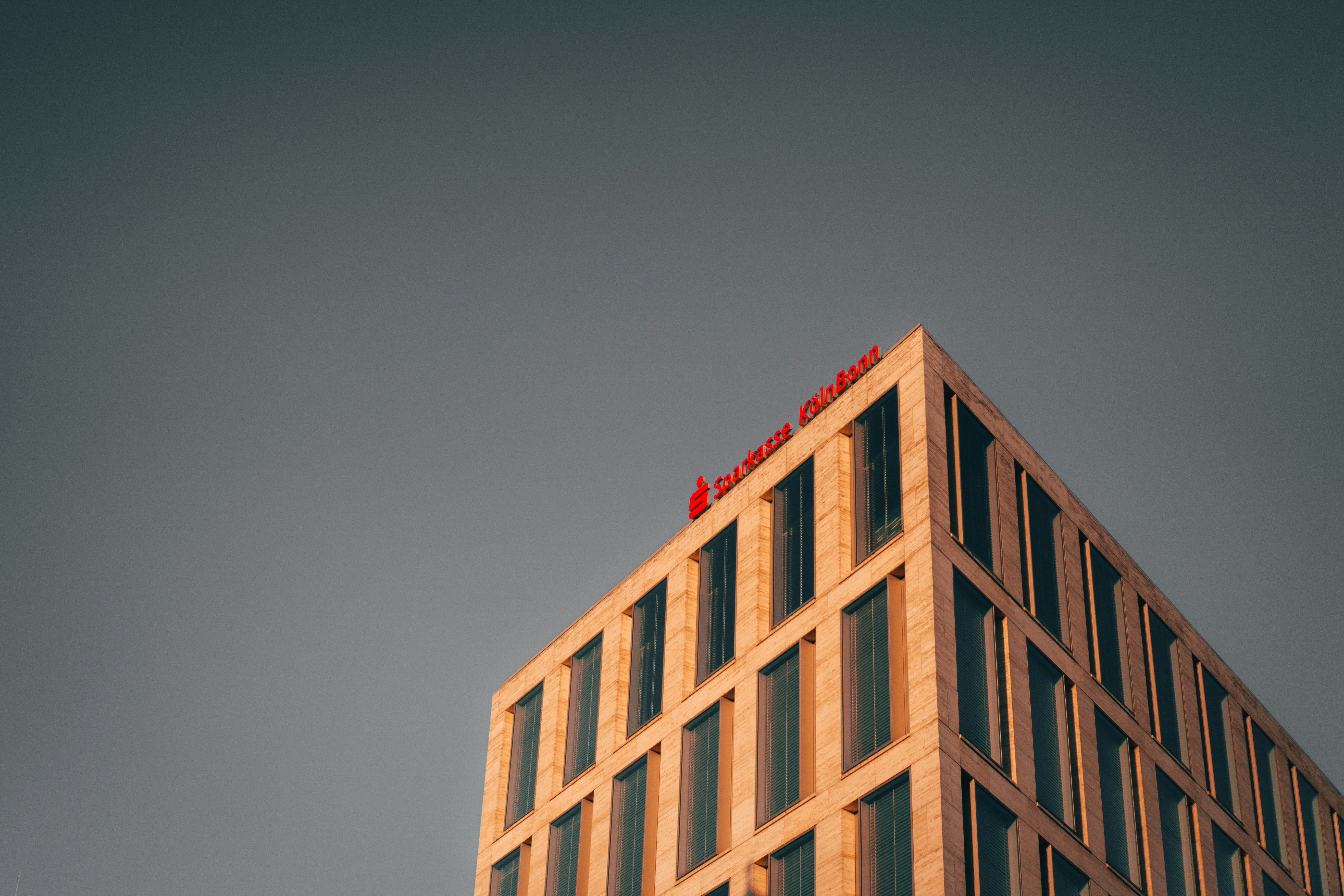 brown concrete building under gray sky